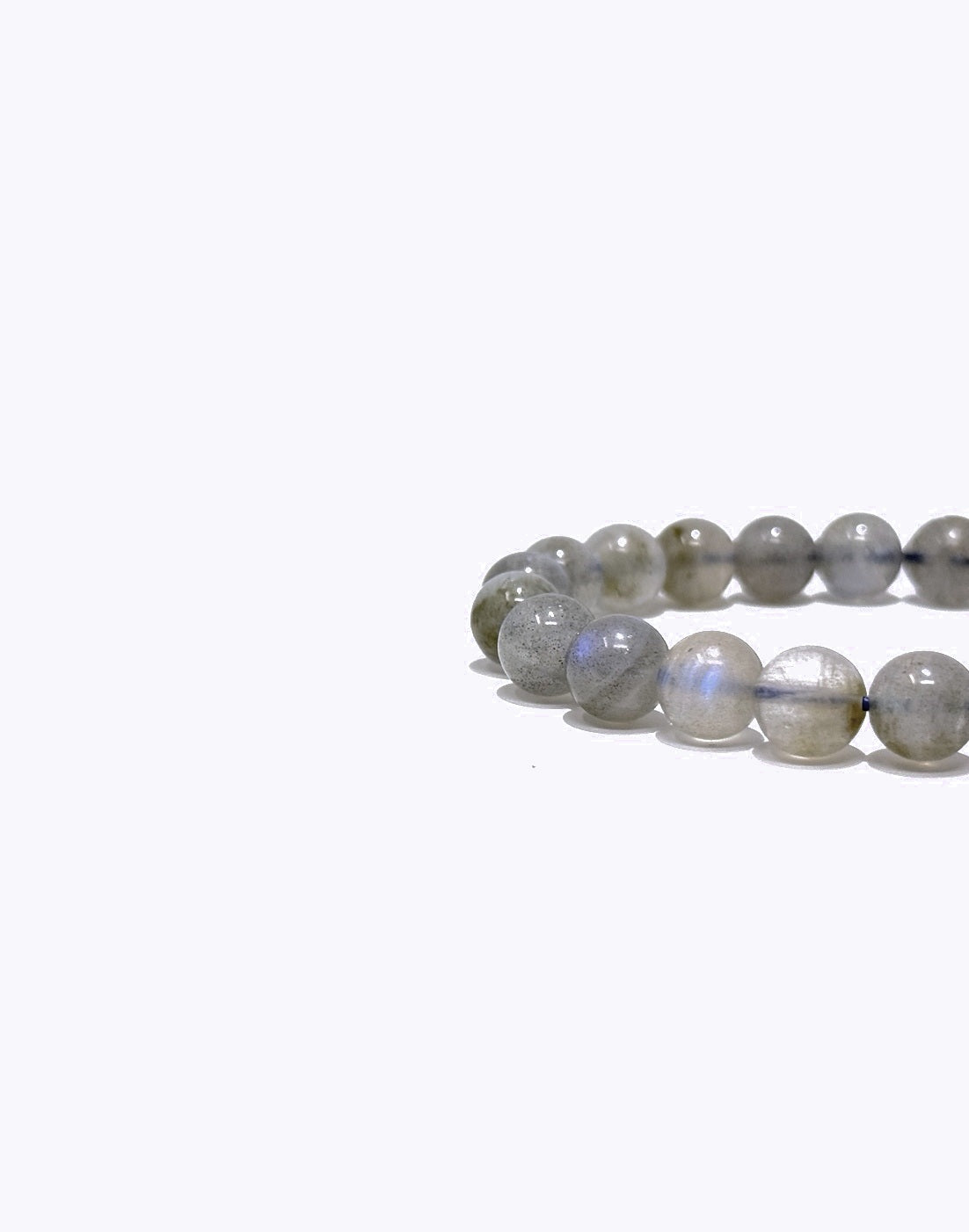 A beaded stretch bracelet made of polished gray labradorite beads with a subtle blue iridescent sheen, shown on a plain white background.